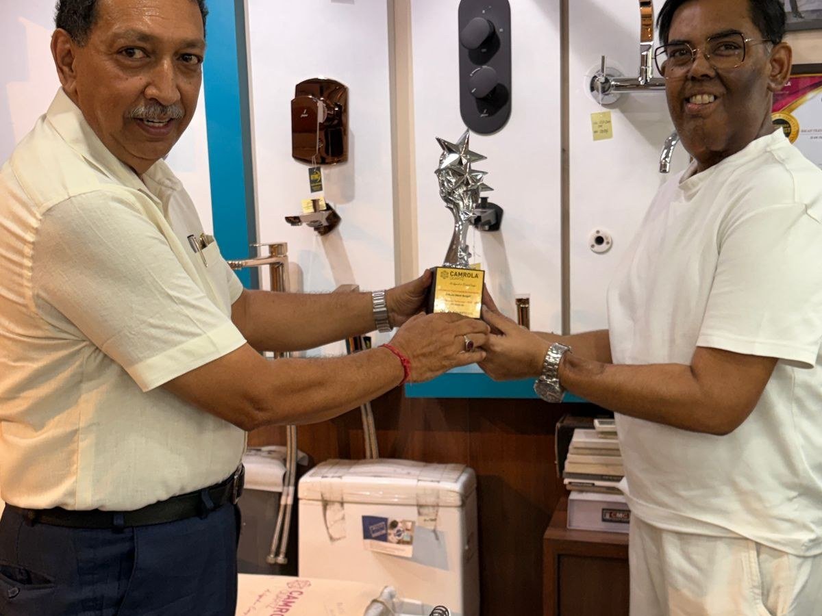 Receiving the Camrola Quartz dealership award at the showroom